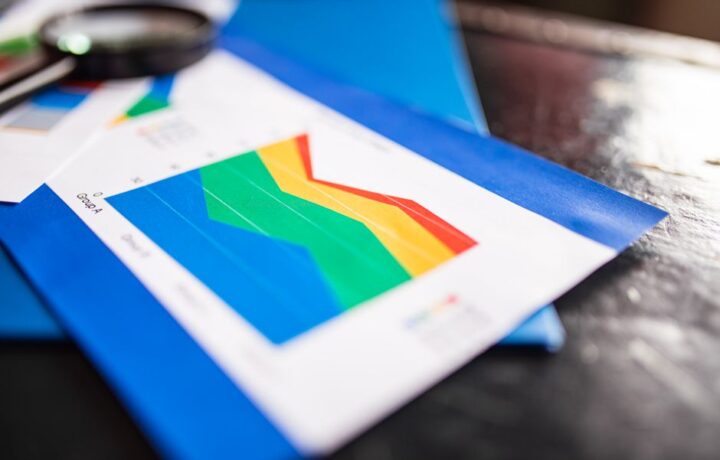 Close-up of a colorful business chart placed on a table with documents highlighting trends.